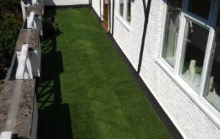 artificial grass next to white house