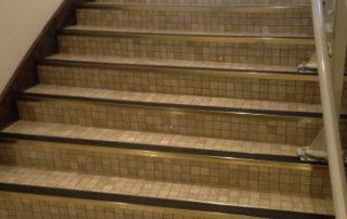 cream tiled stairs with black edges
