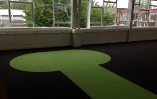 green motif on dark flooring